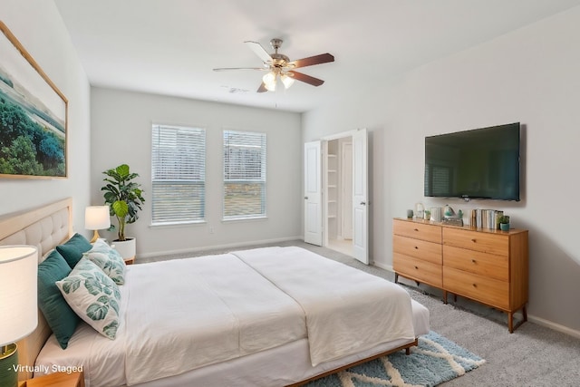 bedroom featuring light carpet and ceiling fan