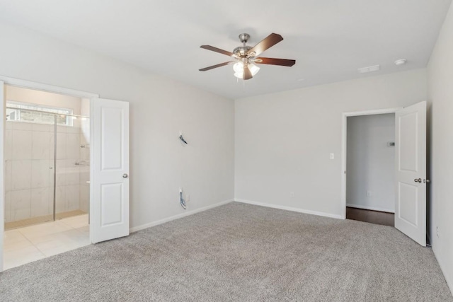 unfurnished bedroom with light colored carpet, ceiling fan, and ensuite bath