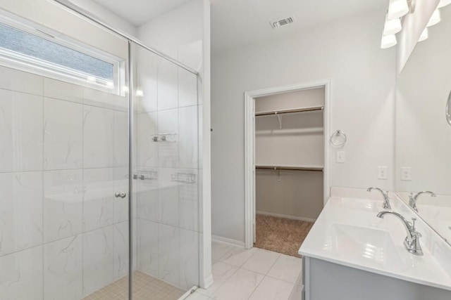 bathroom featuring vanity and an enclosed shower