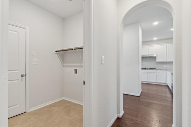 laundry room with hookup for a washing machine and light hardwood / wood-style flooring