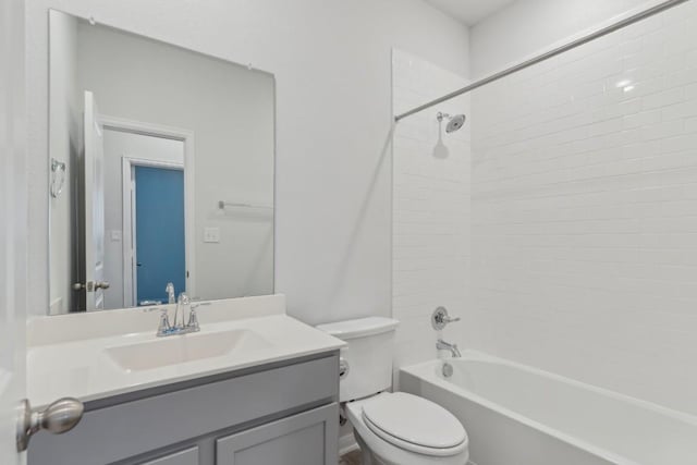 full bathroom featuring vanity, tiled shower / bath combo, and toilet