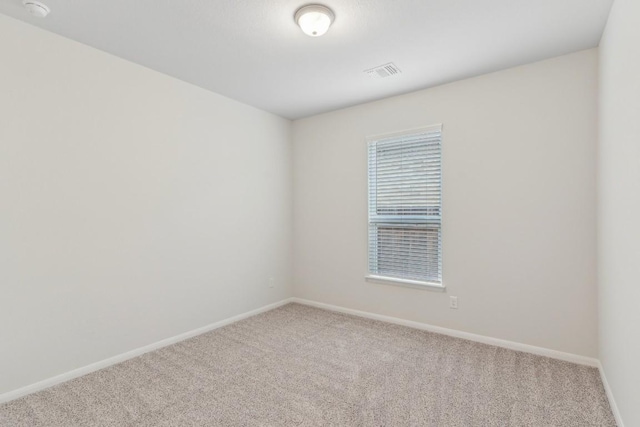 spare room featuring carpet floors