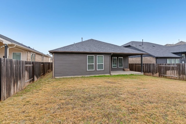 rear view of house featuring a lawn and a patio area