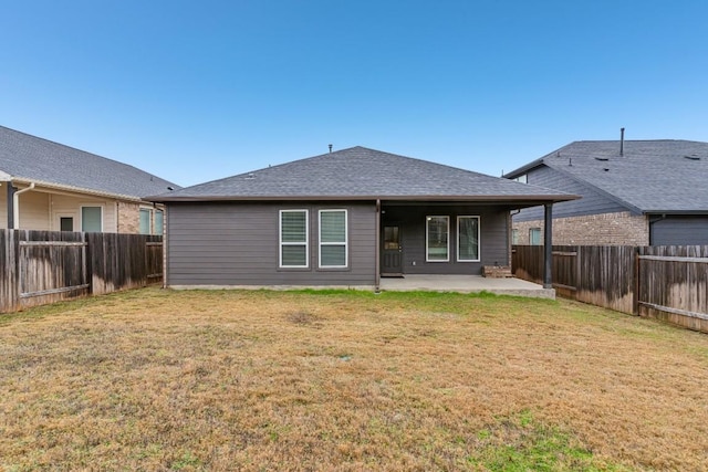 back of house with a lawn and a patio area