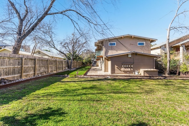 rear view of property with a patio and a yard