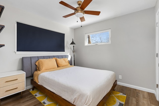 bedroom with dark wood-type flooring and ceiling fan