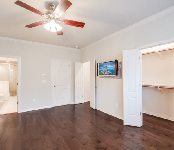 interior space featuring crown molding, dark hardwood / wood-style flooring, and a closet