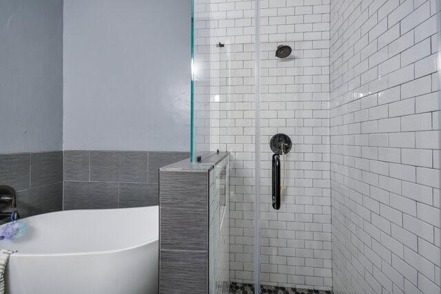 bathroom with shower with separate bathtub