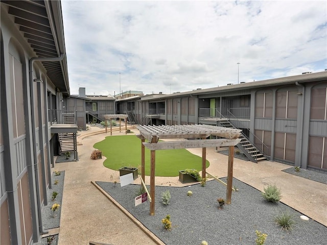 view of community featuring a patio area and a pergola