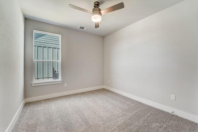 carpeted empty room featuring ceiling fan