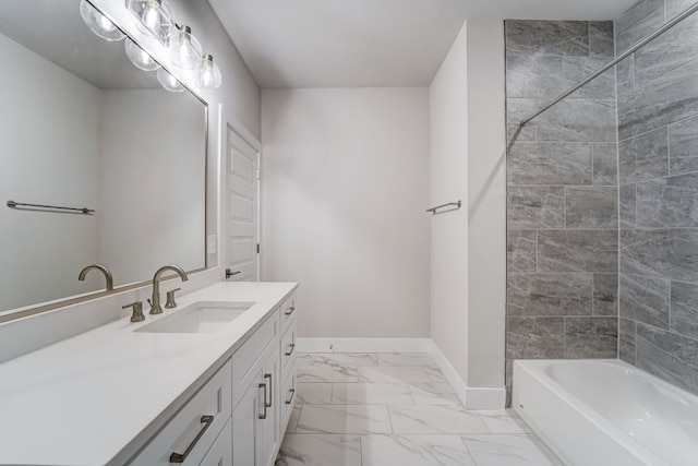 bathroom featuring vanity and tiled shower / bath