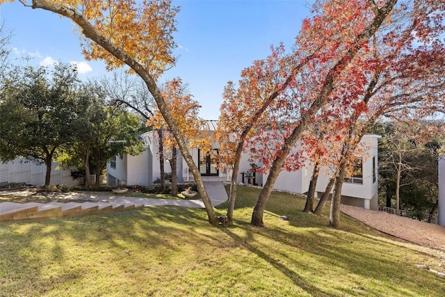 2102 N Oak Canyon Rd, Austin, TX 78746 - obstructed view of property featuring a front lawn and stucco siding