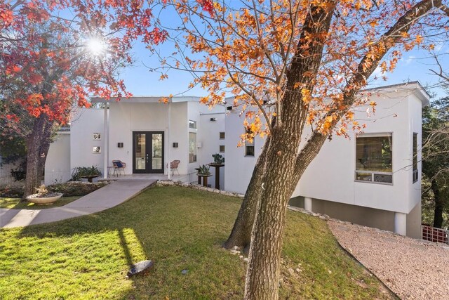 2102 N Oak Canyon Rd, Austin, TX 78746 - contemporary home featuring french doors, stucco siding, and a front yard