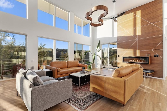 2102 N Oak Canyon Rd, Austin, TX 78746 - living area with a high ceiling, wood finished floors, and a glass covered fireplace
