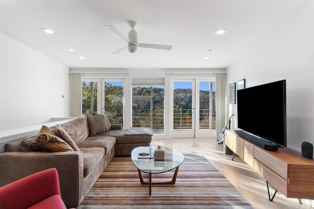 living room featuring ceiling fan and light hardwood / wood-style flooring