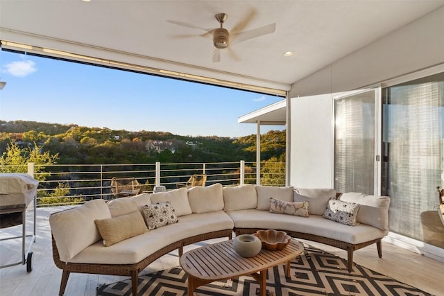 interior space featuring an outdoor hangout area and ceiling fan