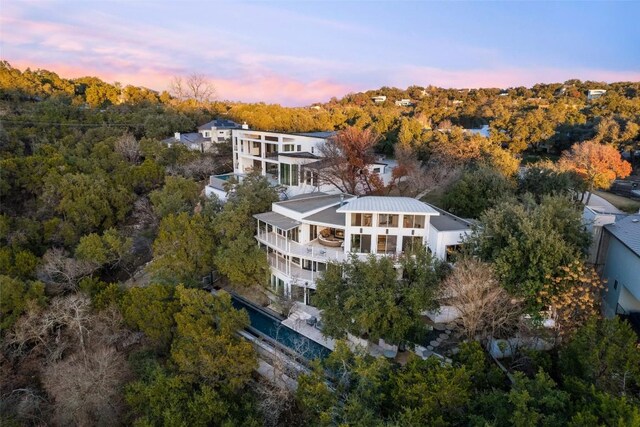 2102 N Oak Canyon Rd, Austin, TX 78746 - aerial view at dusk of a wooded view