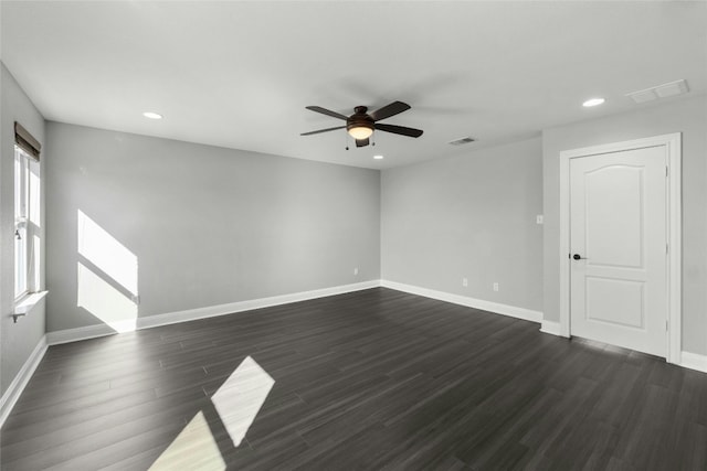 empty room with ceiling fan and dark hardwood / wood-style floors