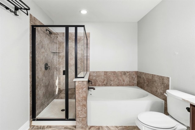 bathroom featuring shower with separate bathtub and toilet