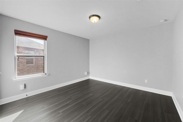 unfurnished room featuring dark wood-type flooring