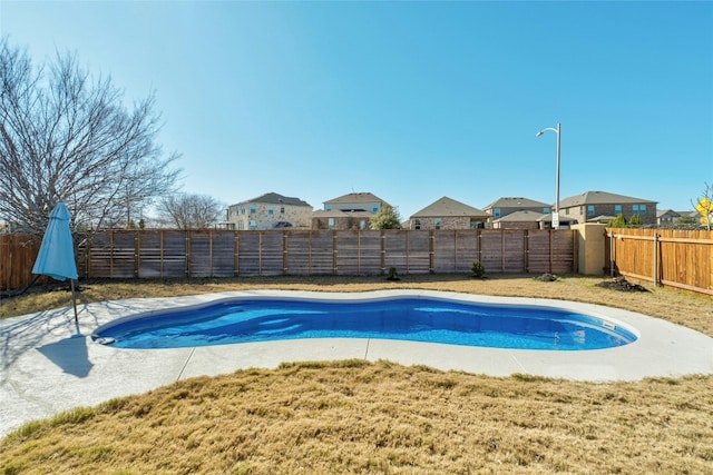 view of swimming pool with a lawn