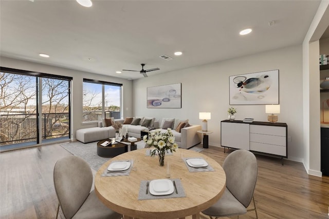 dining space featuring light hardwood / wood-style floors and ceiling fan