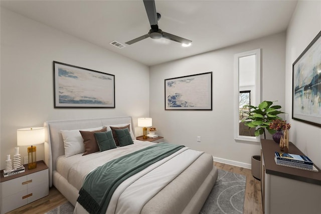 bedroom with light hardwood / wood-style floors and ceiling fan