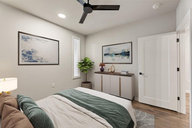 bedroom with wood-type flooring and ceiling fan