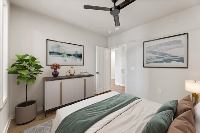 bedroom featuring ceiling fan and light hardwood / wood-style flooring