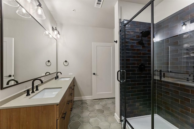 bathroom with vanity, tile patterned flooring, and a shower with door