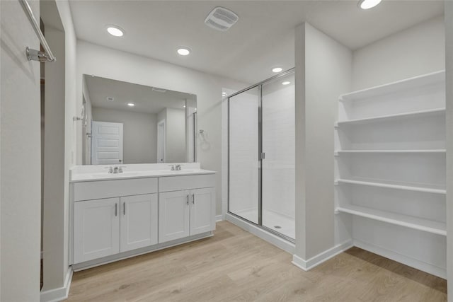 650 Radley Rd, Lockhart, TX 78644 - bathroom with hardwood / wood-style flooring, vanity, and an enclosed shower