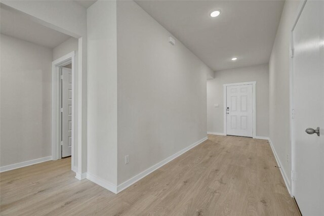 hallway with light hardwood / wood-style flooring