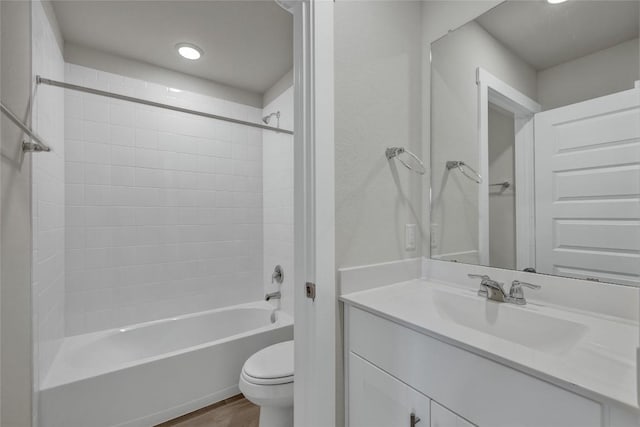 650 Radley Rd, Lockhart, TX 78644 - full bathroom featuring hardwood / wood-style flooring, vanity, toilet, and tiled shower / bath combo