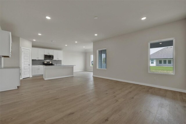 650 Radley Rd, Lockhart, TX 78644 - unfurnished living room featuring light hardwood / wood-style flooring and a wealth of natural light