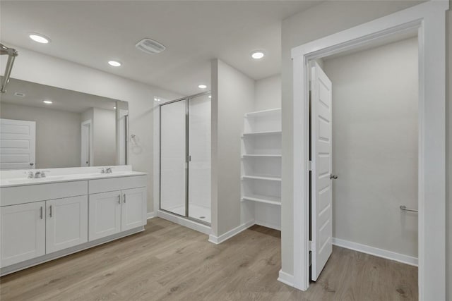 650 Radley Rd, Lockhart, TX 78644 - bathroom with vanity, a shower with door, and hardwood / wood-style floors