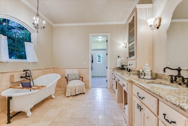 bathroom with ornamental molding, a bathing tub, vanity, and tile walls