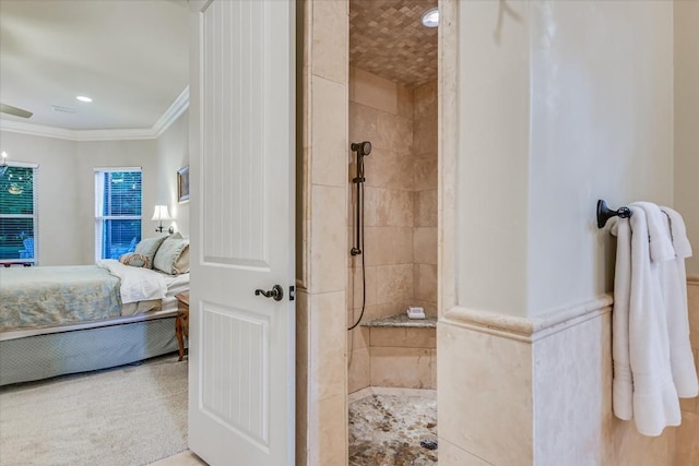 bathroom featuring crown molding and a tile shower