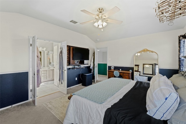 carpeted bedroom with vaulted ceiling, ensuite bathroom, and ceiling fan