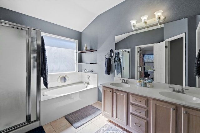 bathroom with tile patterned flooring, vanity, vaulted ceiling, and separate shower and tub