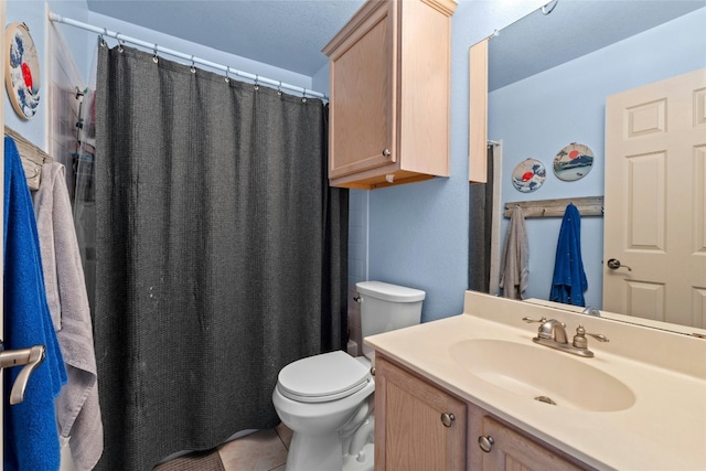 bathroom featuring vanity, curtained shower, and toilet