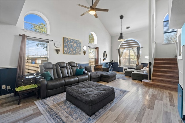 living room with ceiling fan, high vaulted ceiling, and hardwood / wood-style floors