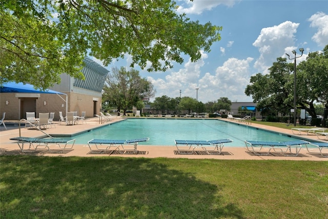 view of pool featuring a yard and a patio