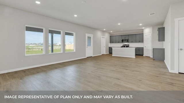 unfurnished living room with light hardwood / wood-style flooring