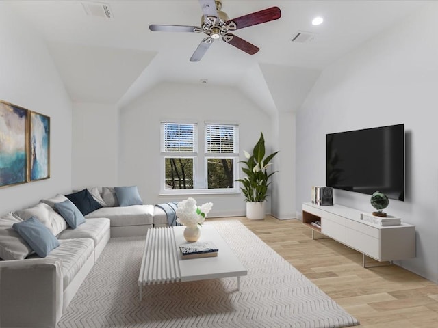 living room featuring light hardwood / wood-style flooring, ceiling fan, and vaulted ceiling