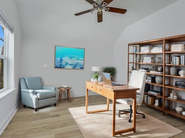 office featuring vaulted ceiling, ceiling fan, a healthy amount of sunlight, and light hardwood / wood-style floors