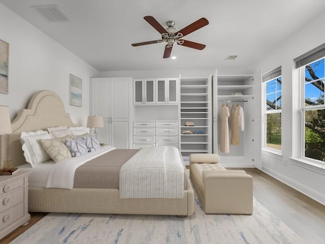 bedroom with ceiling fan and light hardwood / wood-style floors