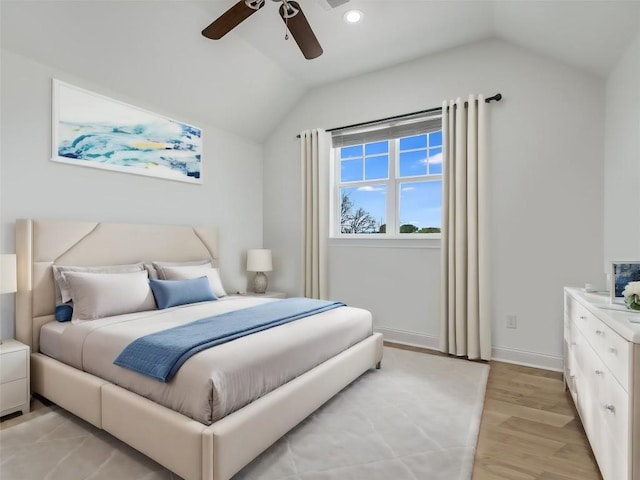 bedroom with lofted ceiling, light hardwood / wood-style floors, and ceiling fan