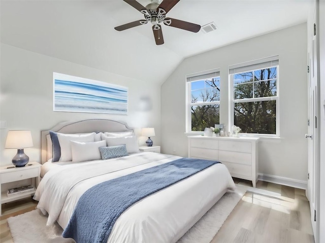 bedroom featuring vaulted ceiling, ceiling fan, and light wood-type flooring