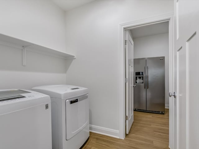 laundry area featuring separate washer and dryer and light wood-type flooring