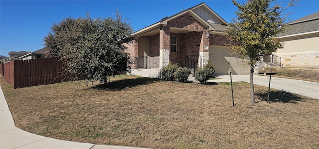 view of property hidden behind natural elements with a garage and a front lawn